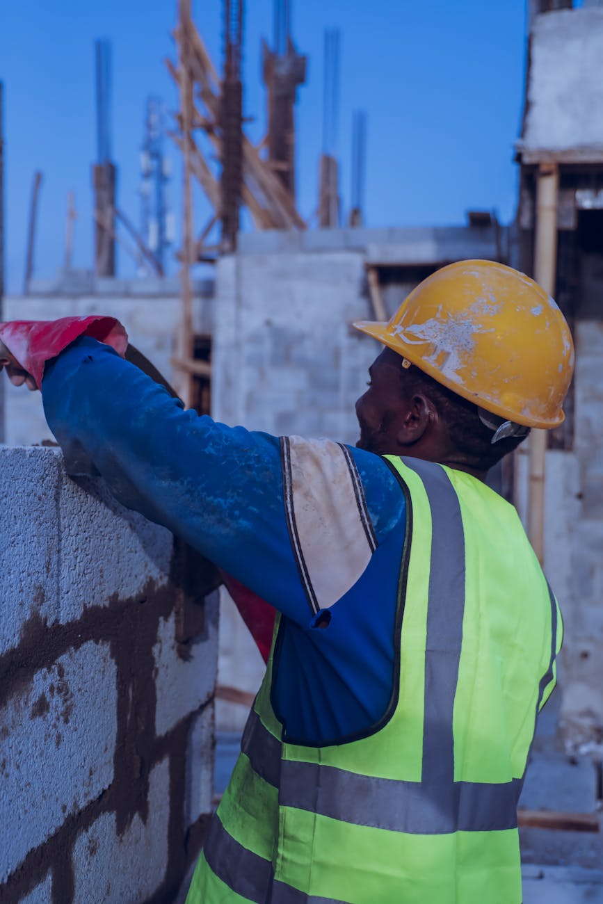 construction worker building a concrete wall