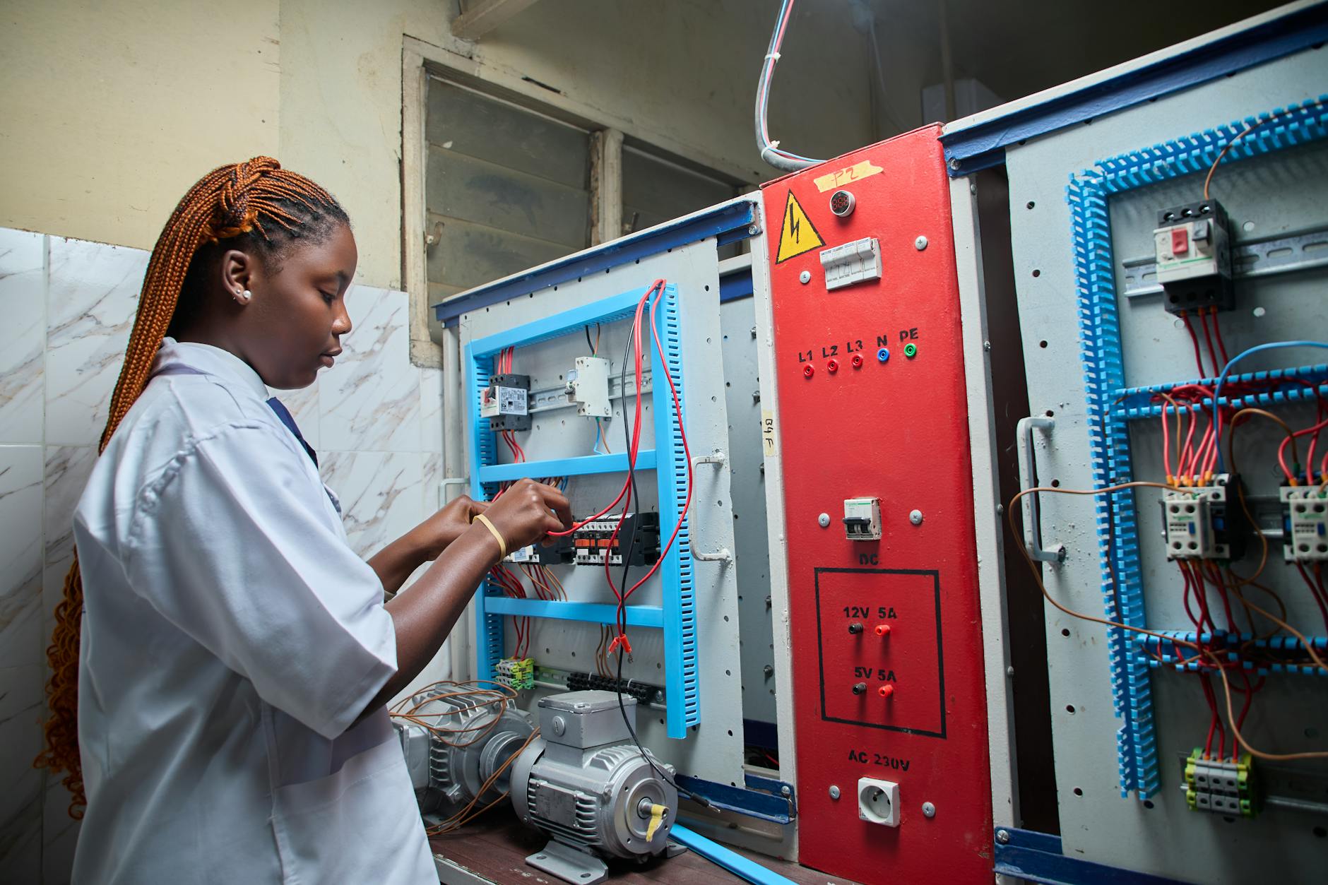 female technician working on electrical control panel