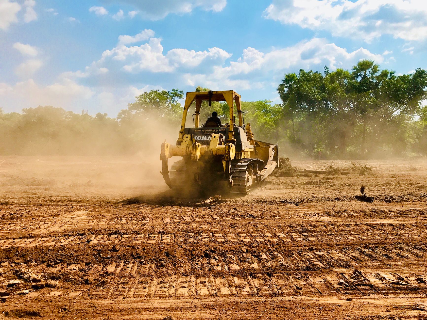 yellow and black heavy equipment on brown field